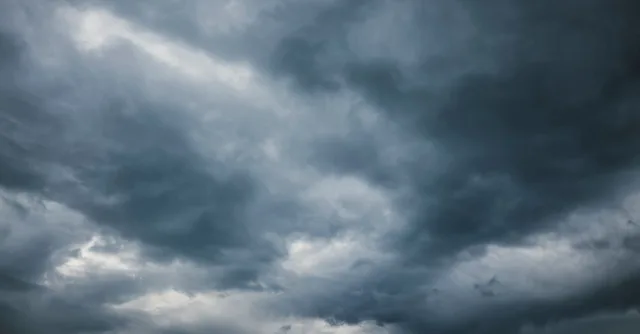Moody sky with thick storm clouds, capturing the essence of an approaching storm.
