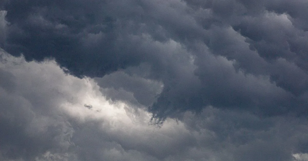 A captivating image of dense, dark clouds in a dramatic overcast sky, hinting at a storm.