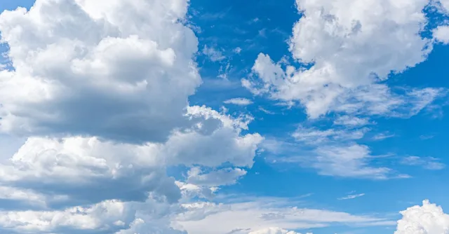 A stunning view of cumulus clouds under a bright blue sky, perfect for serene backgrounds.