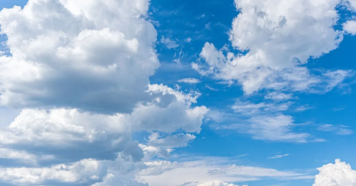 A stunning view of cumulus clouds under a bright blue sky, perfect for serene backgrounds.