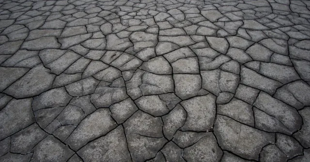 Aerial view of cracked, dry land symbolizing drought and climate impact.
