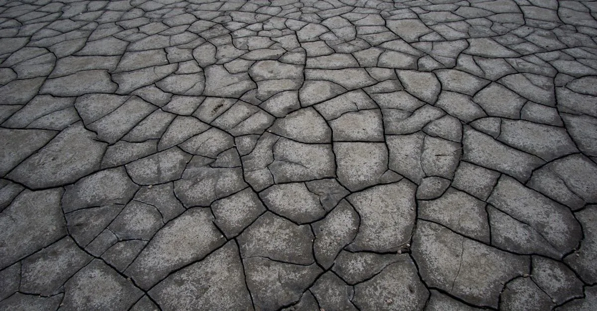 Aerial view of cracked, dry land symbolizing drought and climate impact.