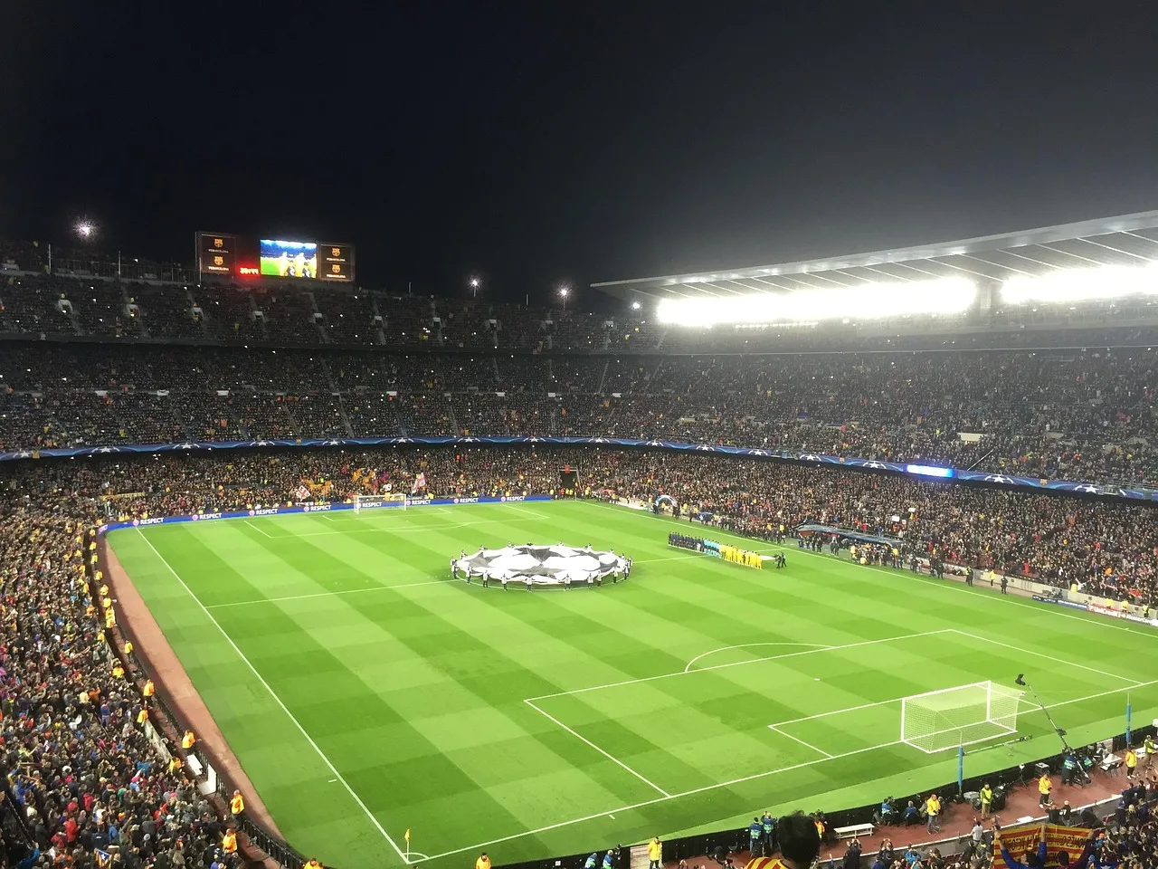 A professional football stadium illuminated under floodlights for an international match.