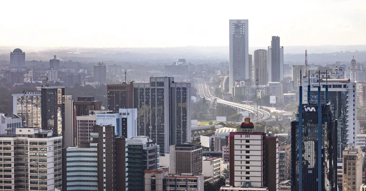 Aerial view of Nairobi's modern skyscrapers and bustling urban landscape under a clear sky.