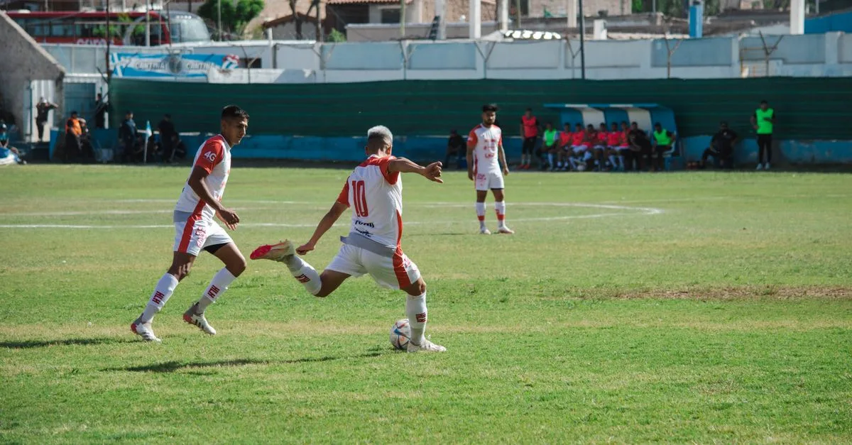 Intense soccer game in Mina, Mendoza, Argentina showcasing teamwork and action on a sunny day.