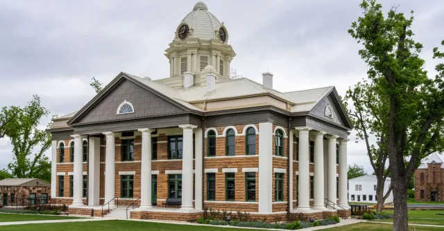 Elegant architecture of Mason County Courthouse in Texas against a cloudy sky.