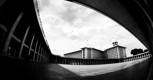 A striking black and white image of modern urban architecture with a wide angle perspective.