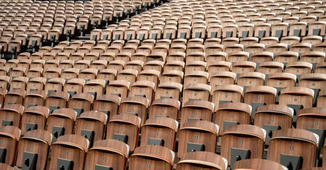 Wooden seats in a vast amphitheater in Avignon, Provence, showcasing patterns and symmetry.