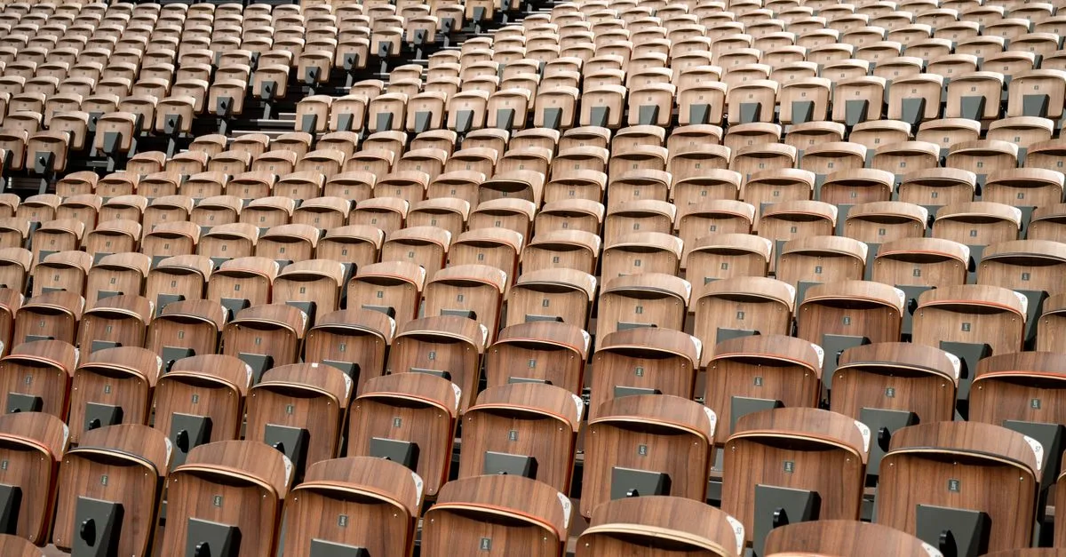 Wooden seats in a vast amphitheater in Avignon, Provence, showcasing patterns and symmetry.