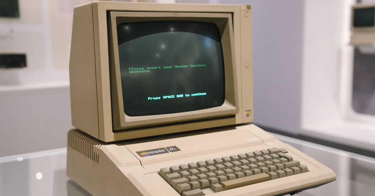 Retro Apple II computer in a museum setting, showcasing vintage technology design.