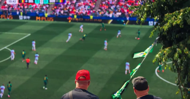 Engaging view of soccer fans enjoying a live match at a stadium in Langford, BC, Canada.