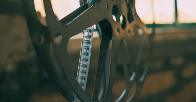 Artistic shot of a vintage film reel with soft light creating a nostalgic atmosphere.
