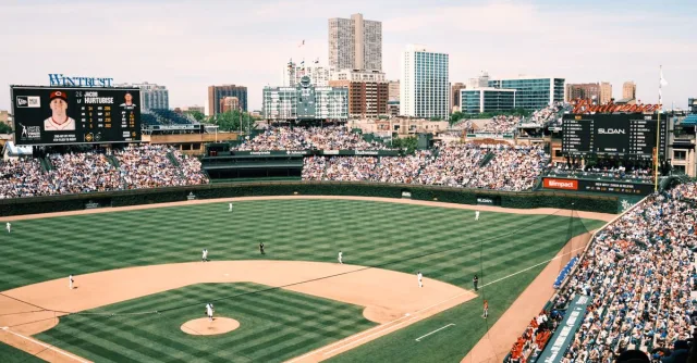 Wide-angle shot of Wrigley Field filled with spectators during a baseball game in Chicago.