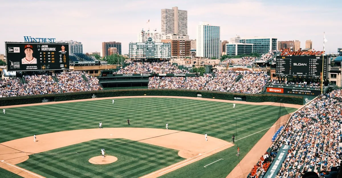 Wide-angle shot of Wrigley Field filled with spectators during a baseball game in Chicago.