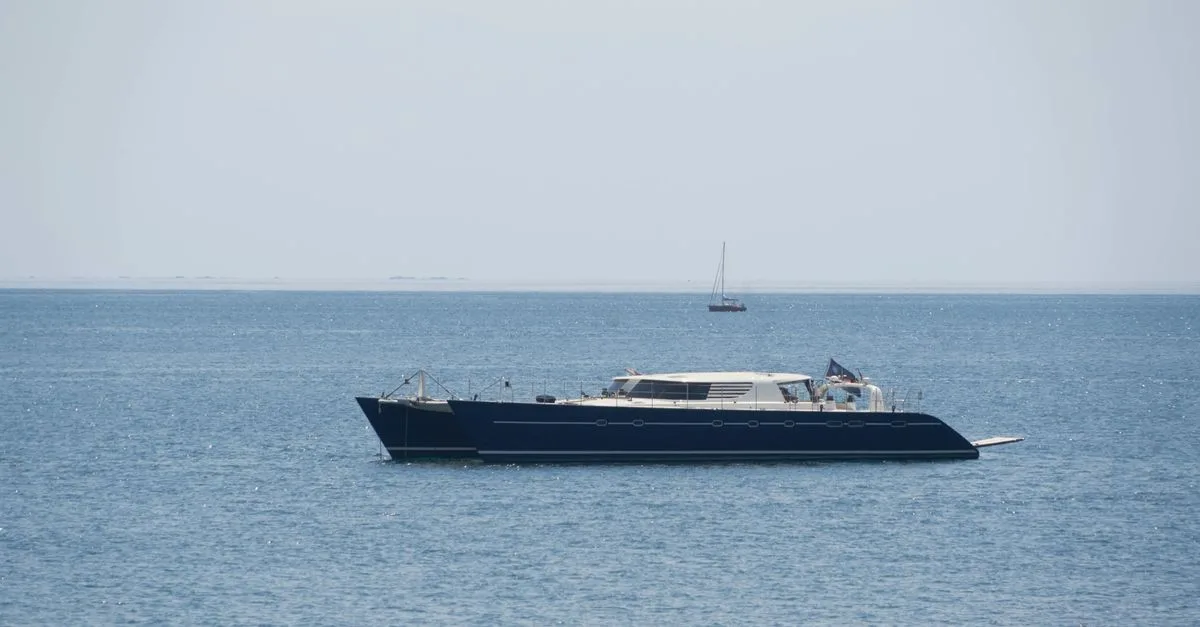 Elegant yacht sailing on the calm blue ocean, epitomizing luxury and travel.