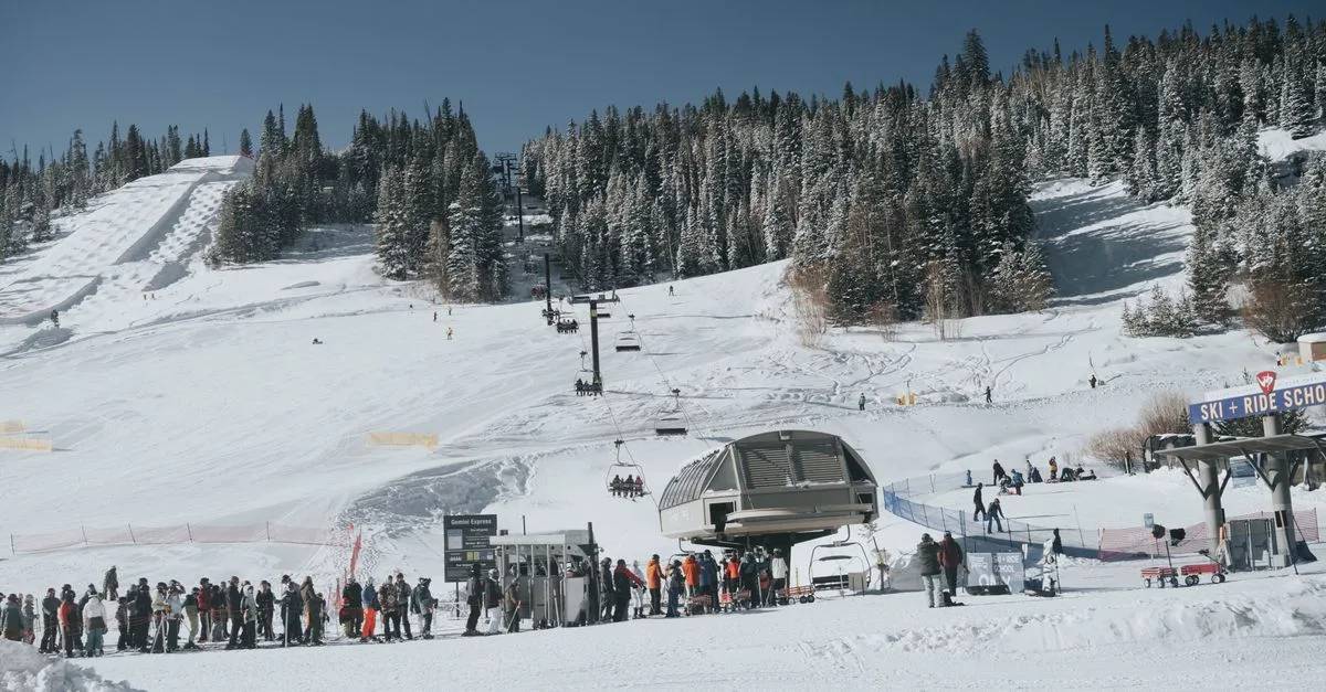 Skiers enjoying a snowy winter day at a Colorado ski resort with chairlifts and ski slopes.