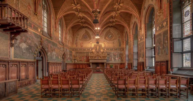 Explore the intricate Gothic architecture of the historic Bruges City Hall interior.