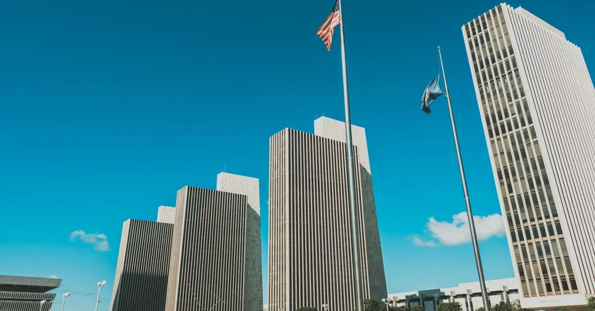 Modern skyscrapers towering at Empire State Plaza in Albany, New York under a clear blue sky.