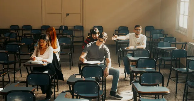 Students sit at desks taking an exam in a university classroom in Buenos Aires, Argentina.