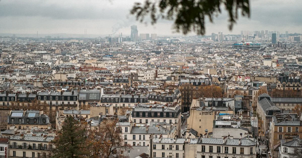 A panoramic view of Paris showcasing classic architecture on a cloudy autumn day.