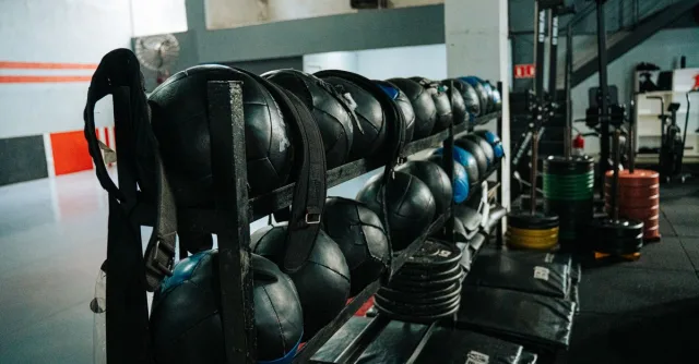 Well-equipped indoor gym featuring kettlebells, weights, and workout gear, perfect for fitness enthusiasts.