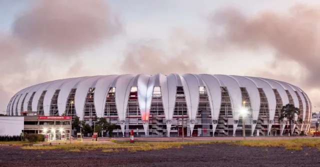 Panoramic view of Estádio Beira-Rio in Porto Alegre at dusk, showcasing its modern design.