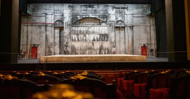 Empty theater stage with backdrop and seating in Paris, France.