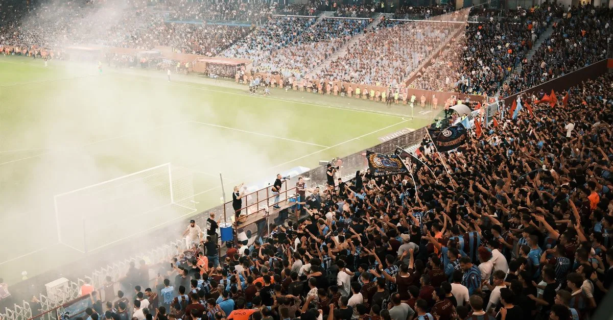 A vibrant scene of a packed soccer stadium with enthusiastic fans cheering during a match.
