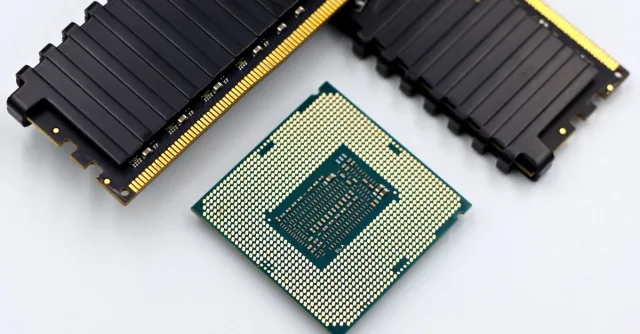 A CPU and RAM sticks displayed on a white surface, showcasing computer hardware components.