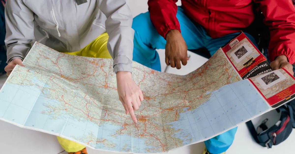Two travelers examining a detailed map for a winter hiking adventure.