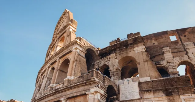 Side view of the Colosseum in Rome captured on a sunny day.