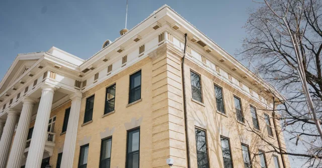 Low angle view of the historic Box Elder County Courthouse with columns and blue sky, Brigham City, Utah.