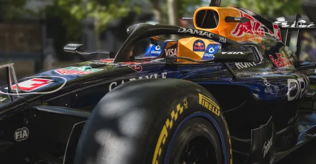 Dynamic shot of a racing car showcasing sleek design and sponsor logos. Perfect for motorsport enthusiasts.