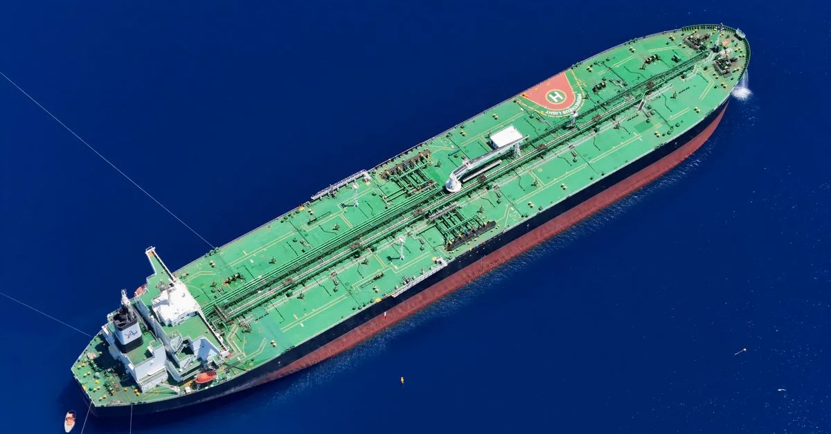 Aerial shot of an oil tanker sailing in the ocean near Vado Ligure, Italy.
