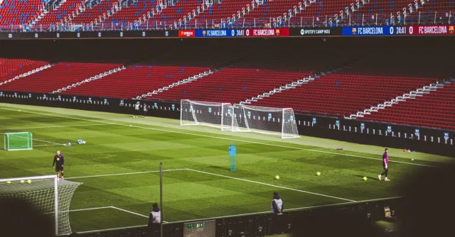 View of empty soccer field at FC Barcelona's Camp Nou with training equipment.