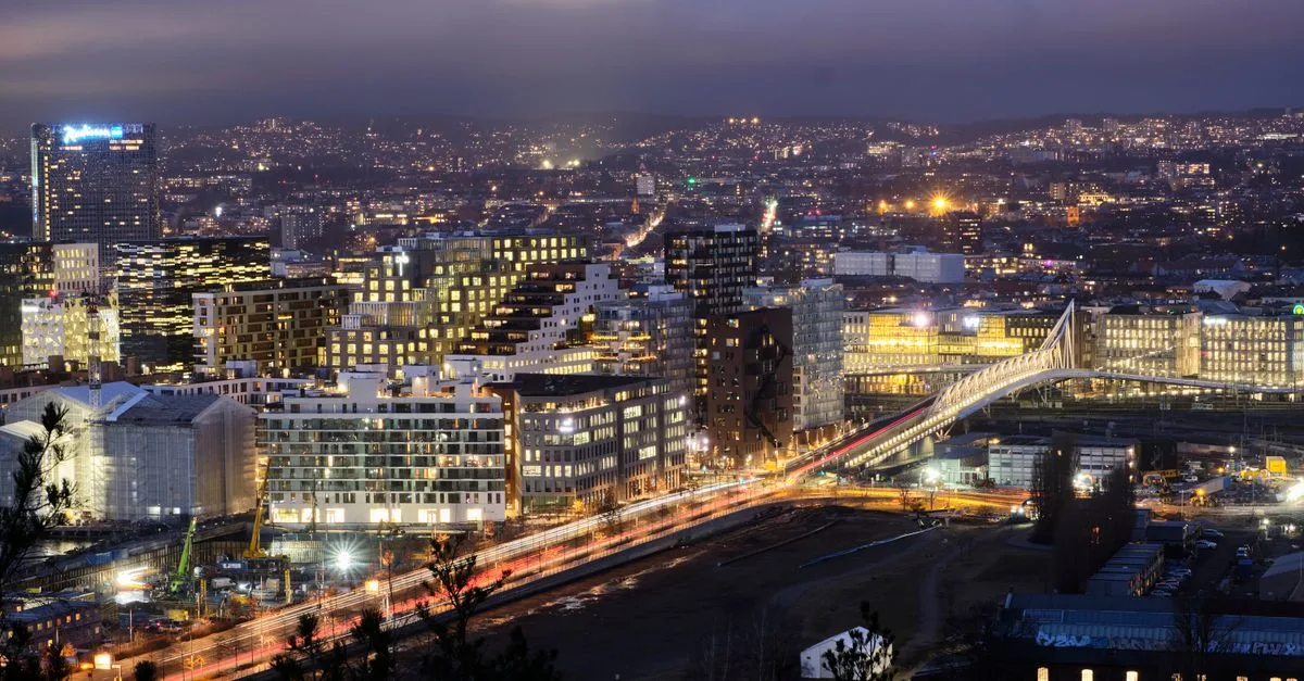 Captivating cityscape featuring illuminated buildings, a bridge with light trails, captured at twilight in an urban setting.