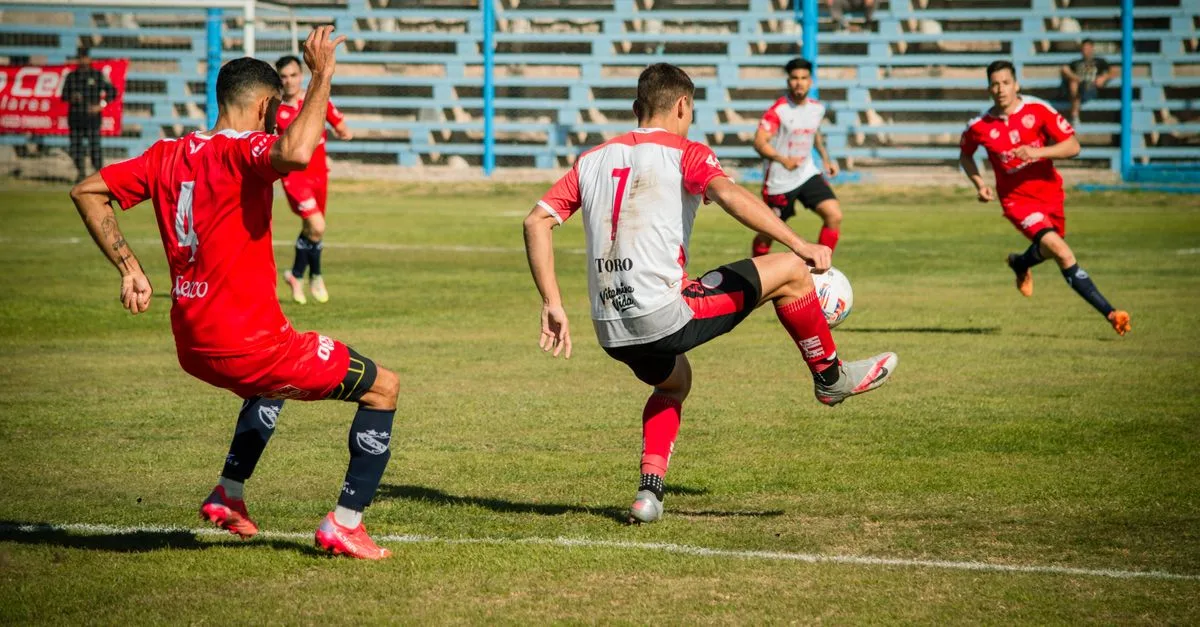 Dynamic soccer match showcasing skillful plays on a sunny day in Mendoza, Argentina.