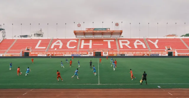 A soccer match underway at Lạch Tray Stadium in Hải Phòng, Vietnam, showcasing vibrant sports action.