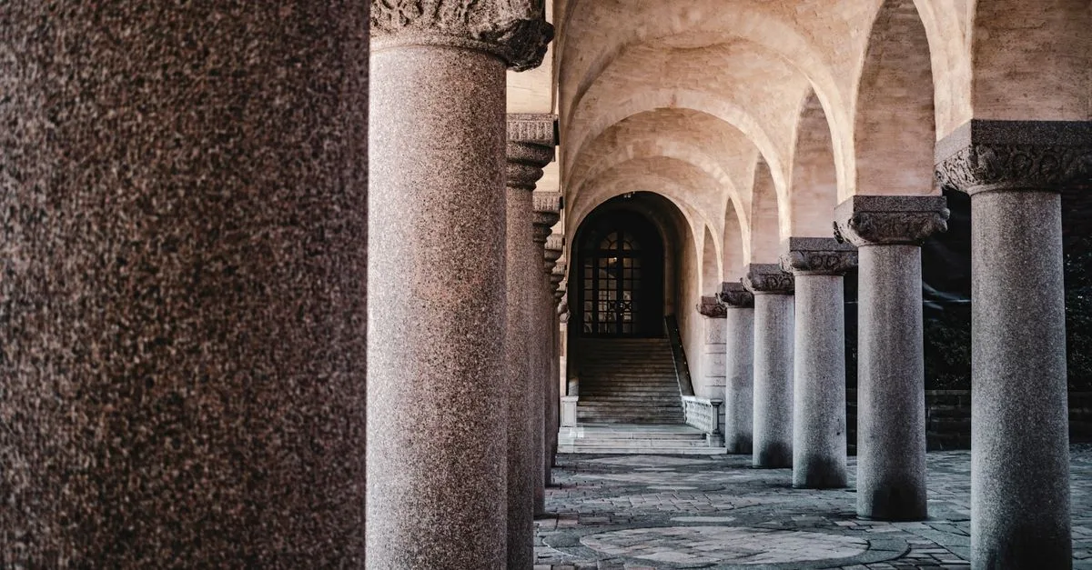 A beautifully detailed corridor with stone columns and arches in Stockholm, Sweden.