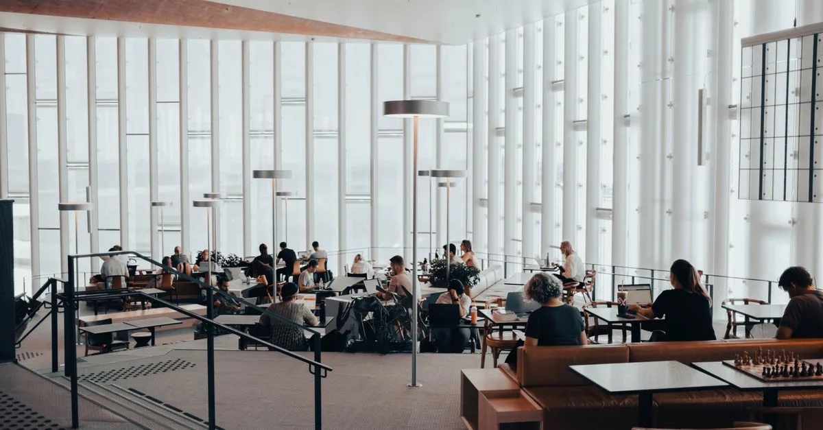 Spacious interior of Oslo public library with people reading and studying.