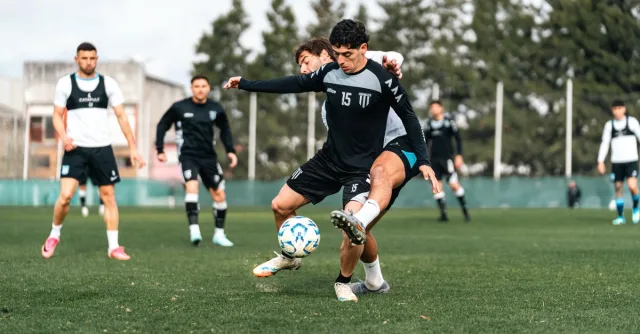Competitive soccer match with focused players in action on a green field, showcasing skills and teamwork.