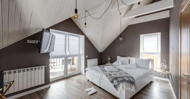 Stylish attic bedroom interior with modern furnishings and a cozy atmosphere.