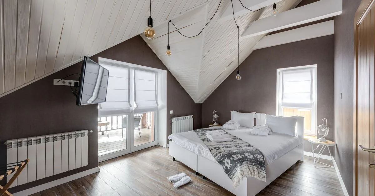 Stylish attic bedroom interior with modern furnishings and a cozy atmosphere.
