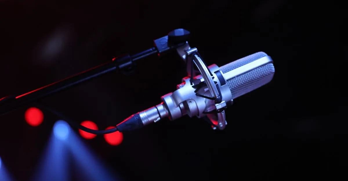 Close-up of a professional microphone on a stage with vibrant lighting in Paris, France.