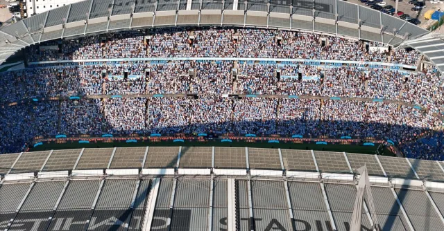 Aerial shot of Etihad Stadium filled with soccer fans in Manchester, UK.