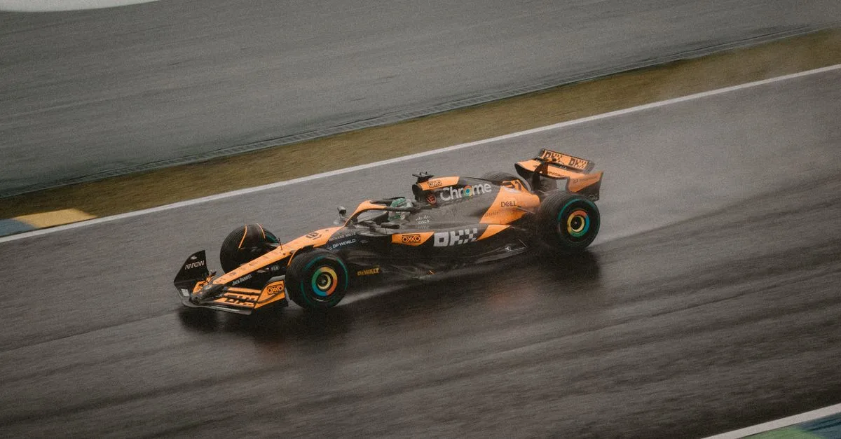 Formula 1 car racing on a wet track, capturing speed and adrenaline.