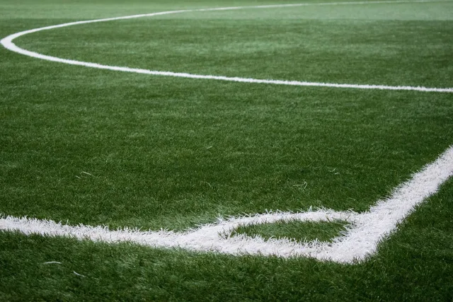 An empty professional soccer stadium field viewed from the stands.