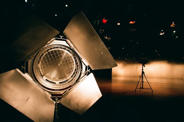 A brightly lit television studio set with game show elements.