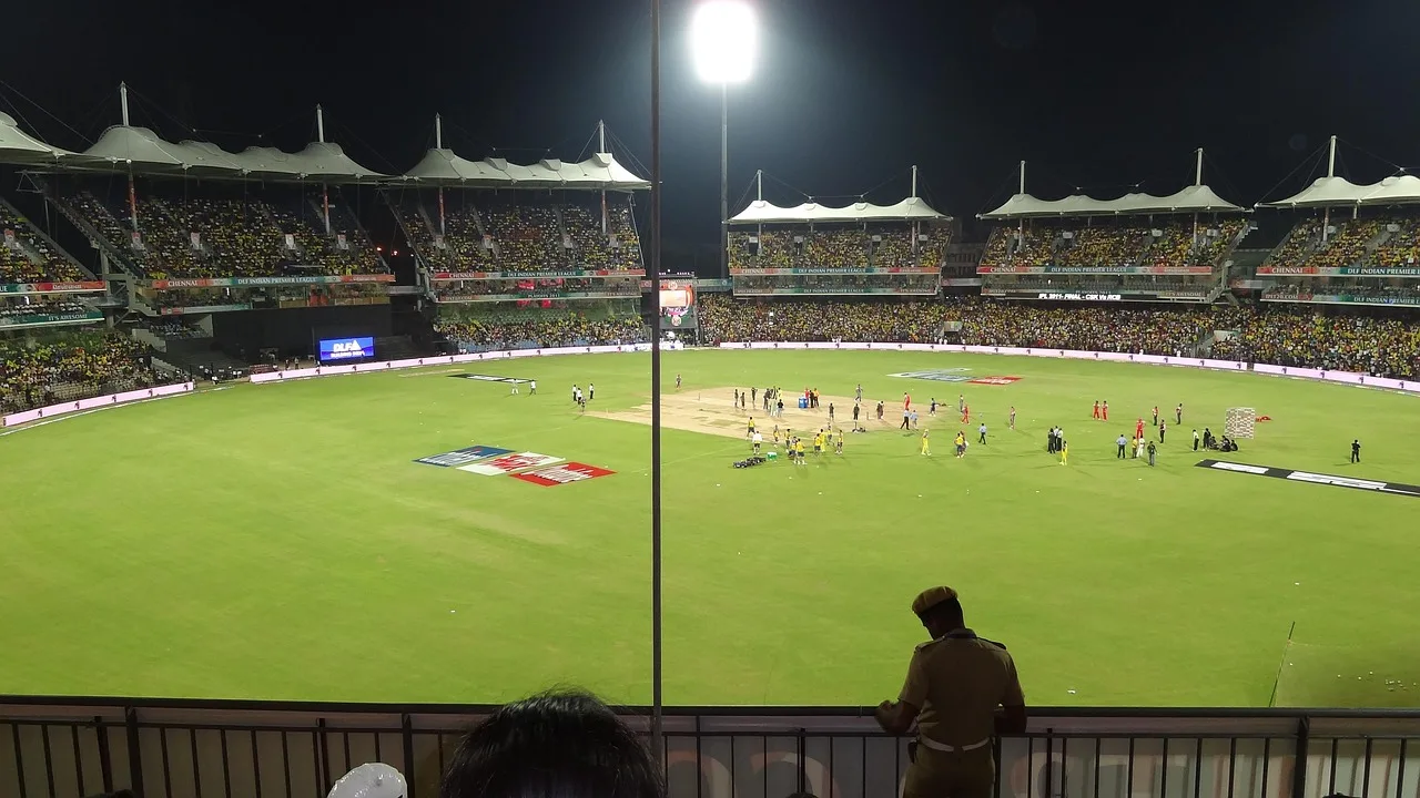A professional cricket pitch at a large stadium during a match.