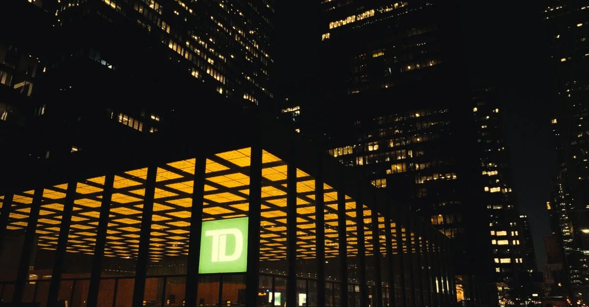 Dramatic nighttime view of Toronto's TD Centre illuminated against the city skyline.